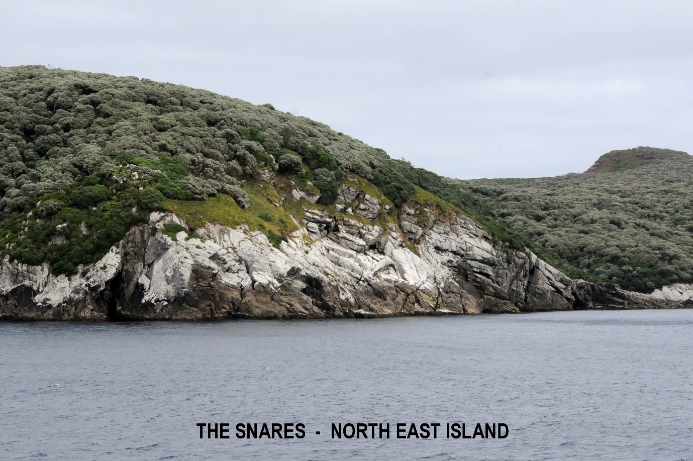 A rocky cliff next to a body of water
Description automatically generated with medium confidence