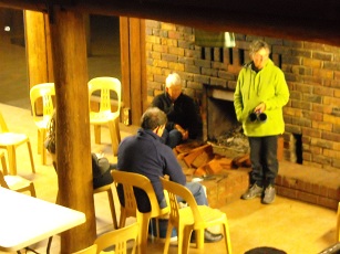 Macadamia shelling in front of fire-Nanga